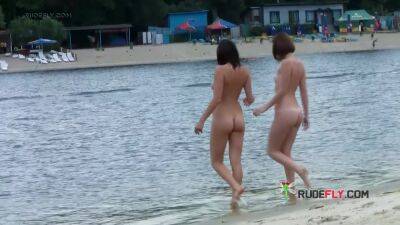 Stunning young nudist babes relax at the beach - hclips.com